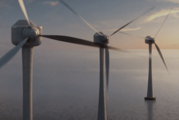 A row of wind turbines standing in the ocean
