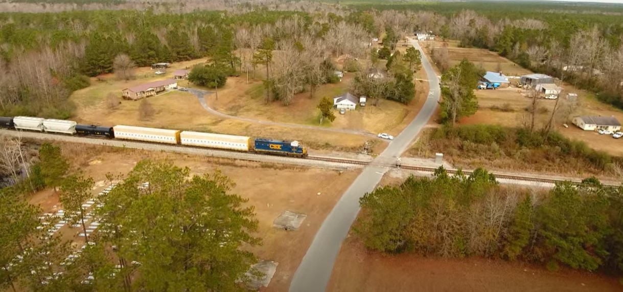 aerial view of a csx train moveing across the mid-atlantic industrial rail park megasite
