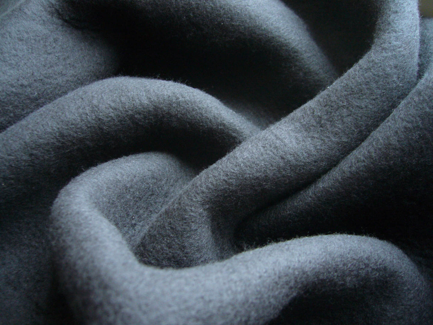 Black jersey fabric with fleece backing. Non-woven fabric textur
