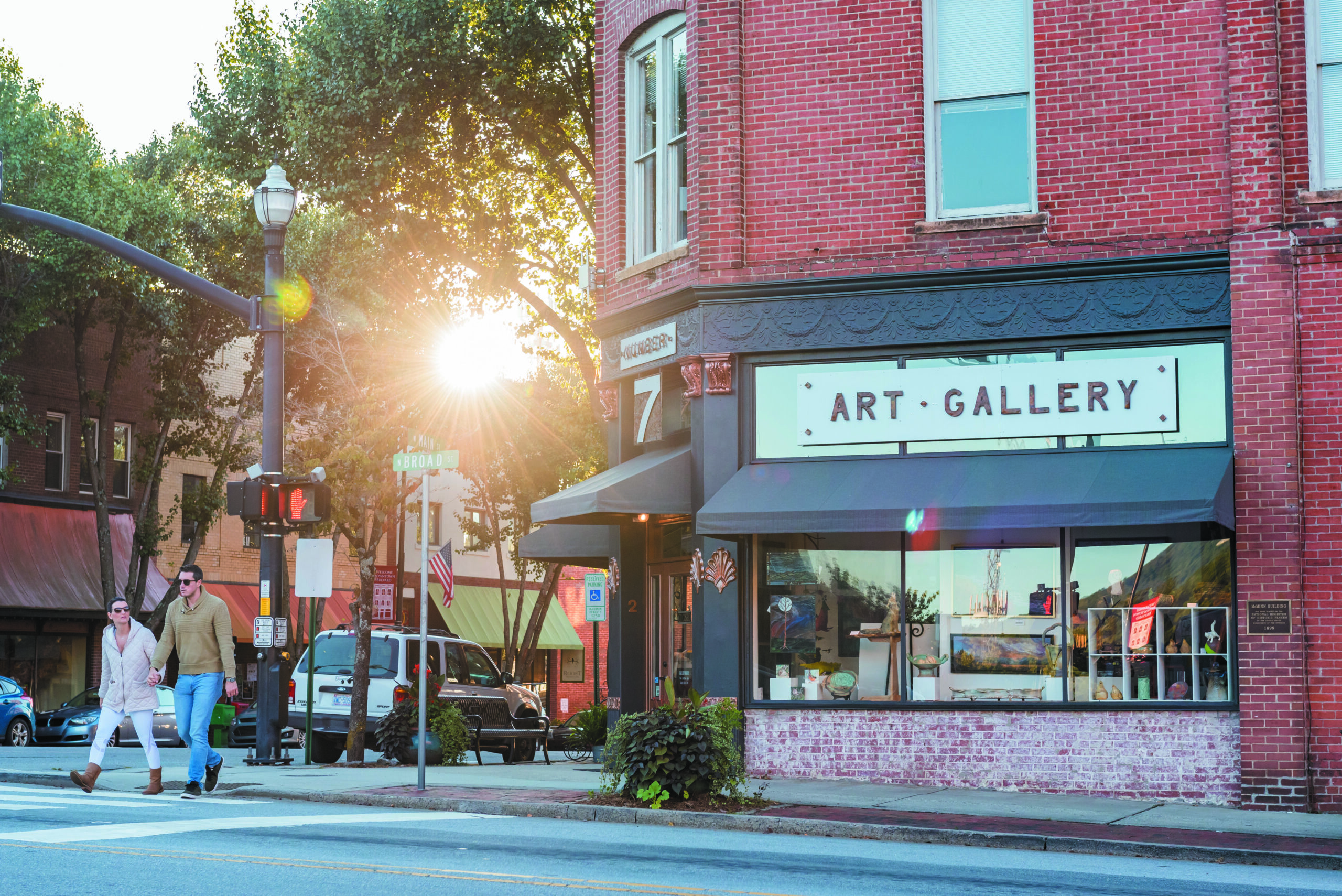 couple walking by art gallery in downtown brevard