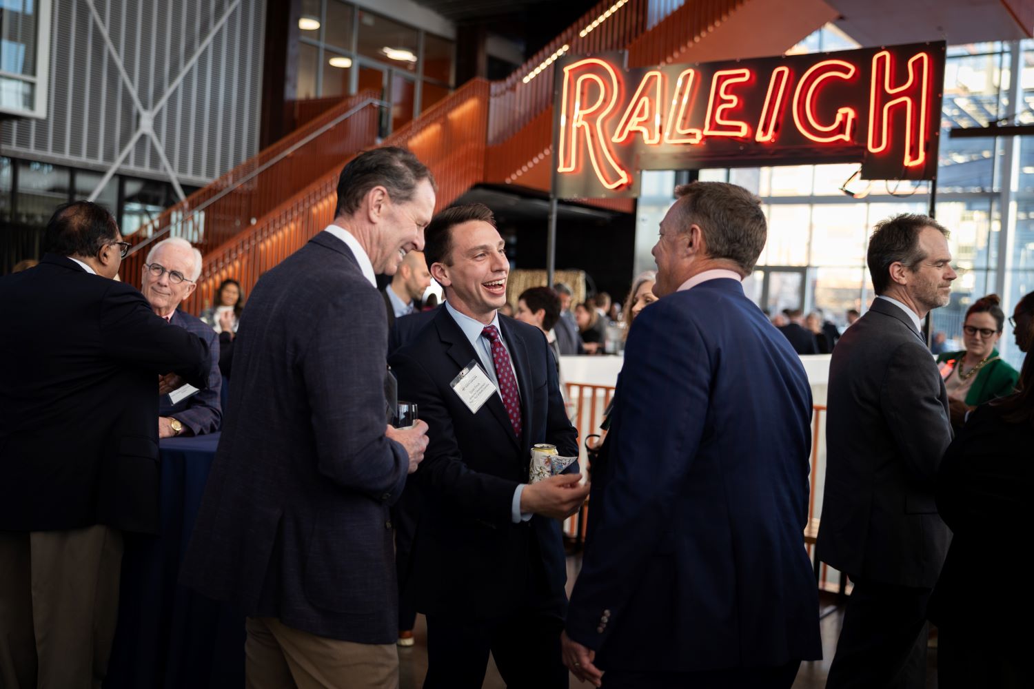 Business men talking at company party