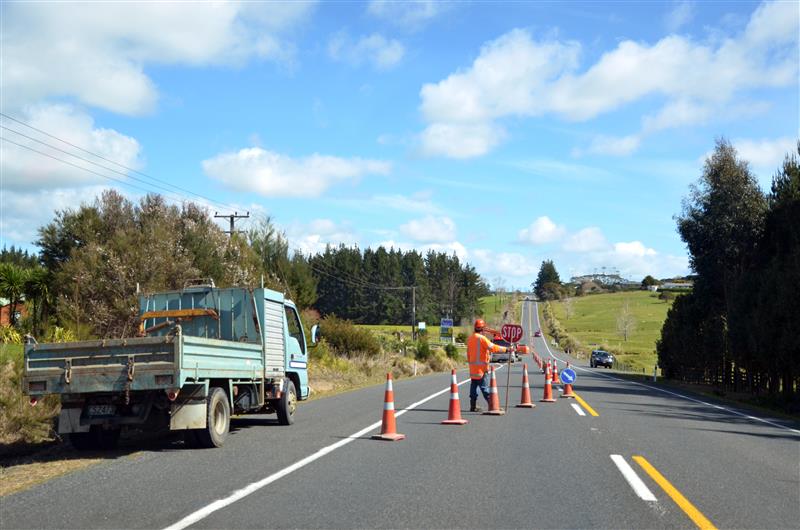 workers directing traffic through public infrastructure improvements