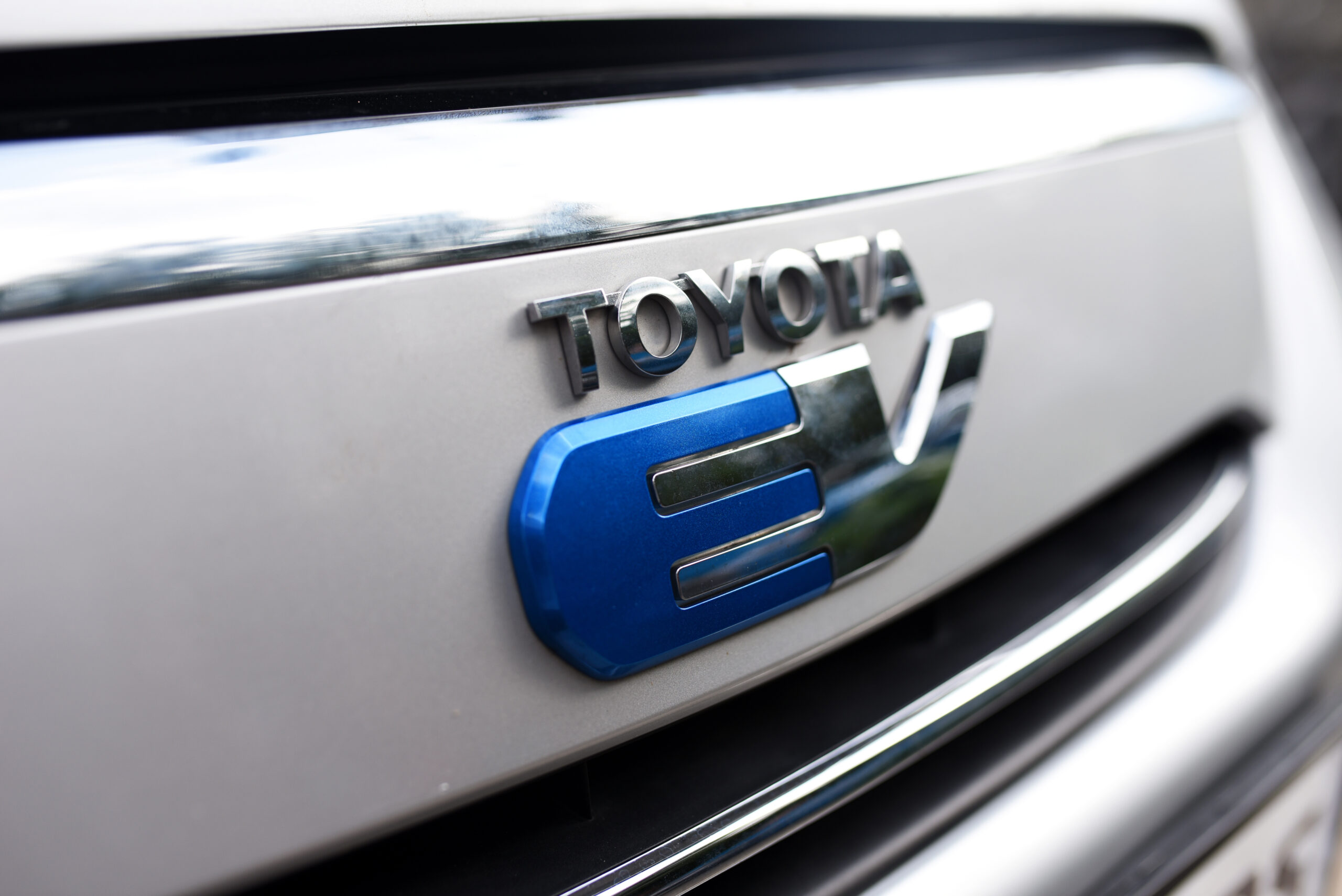 close up shot of toyota logo on electric vehicle
