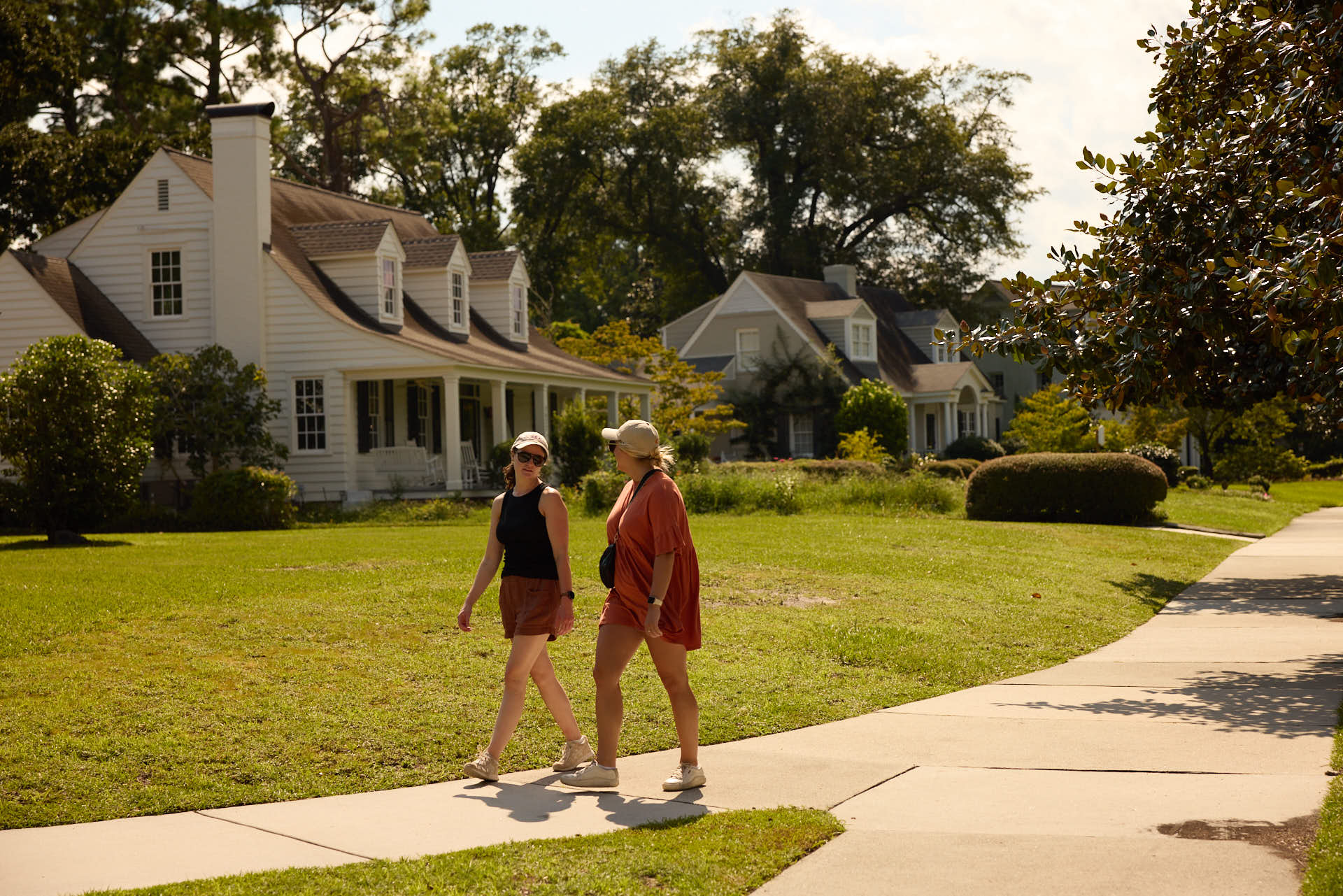 two friends walking through the neighborhood