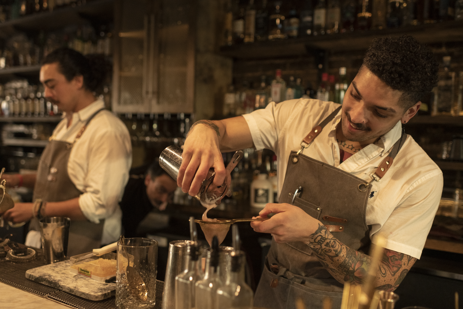 bartender pouring a cocktail in a North Carolina bar
